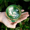 Green and gold mini singing bowl with intricate engraved designs made of metal in mini singing bowl gift set