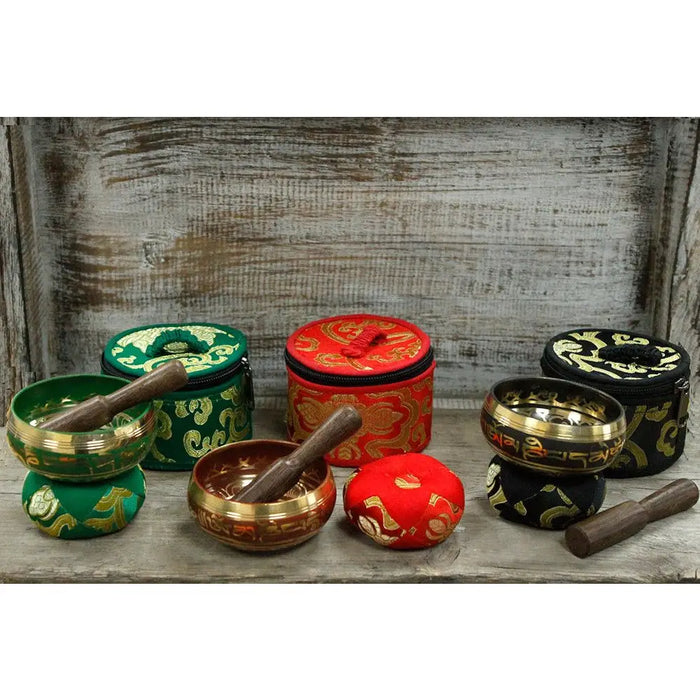 Mini singing bowl gift set with three singing bowls and wooden mallets in green red and black embroidered cases