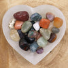 Heart-shaped white selenite dish holding a mix of polished multicolored gemstones 20-30mm weighing 1kg