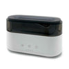 White and black ultrasonic cleaner with three buttons shown alongside a modern aroma diffuser with led clock and flame effect