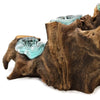 Teal glass five tealight holder resting on textured dark gamal wood driftwood piece