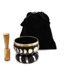 Black singing bowl set with gold rim and moon phase design includes wooden mallet and velvet storage bag