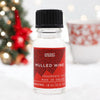 A clear glass bottle of ancient wisdom mulled wine fragrance oil with black cap and red label for christmas use