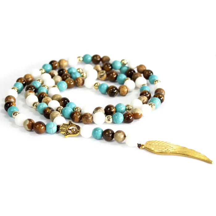 Turquoise brown and white beaded gemstone necklace with gold hamsa charm feather pendant and angel wing detail