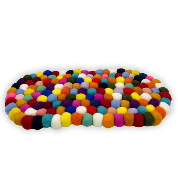 A colorful oval felt ball centre mat made of densely packed multicolored wool balls in vibrant hues
