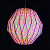 A multi-coloured origami light shade pendant with a geometric striped pattern in red green purple and orange