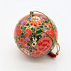 Multi floral hand-painted papier maché bauble with red green and purple floral patterns outlined in gold