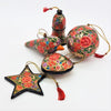 Multi floral hand-painted papier maché bauble with vibrant red green and gold floral patterns on a black base