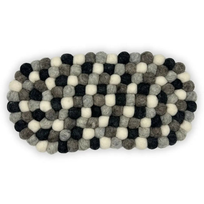 An oval centre mat made of interwoven black white and gray wool felt balls