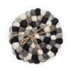 Round felt coasters made of black white and gray wool balls tied with natural twine set of 4