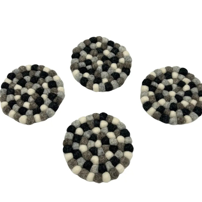 Multi-grey felt ball coasters round set of 4 made of black white and gray woolen balls in concentric pattern