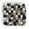 A square felt ball coaster in multi-grey colors made of woven wool balls tied with natural twine set of 4