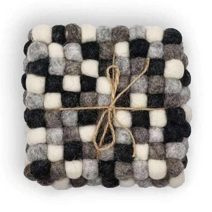 A square felt ball coaster in multi-grey colors made of woven wool balls tied with natural twine set of 4