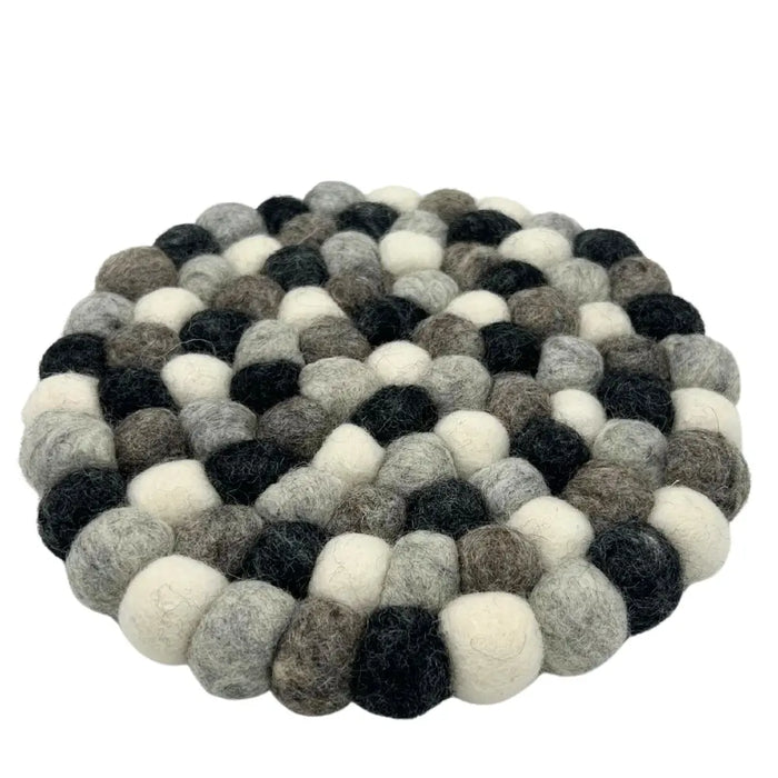Round multi-grey felt ball placemat made of tightly arranged woolen balls in black white and gray shades