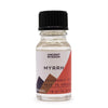 A clear glass bottle of myrrh fragrance oil with a black cap and a geometric label showing allergen declarations