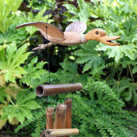 Hand carved wooden duck wind chime with natural brown finish and bamboo wind tubes hanging below