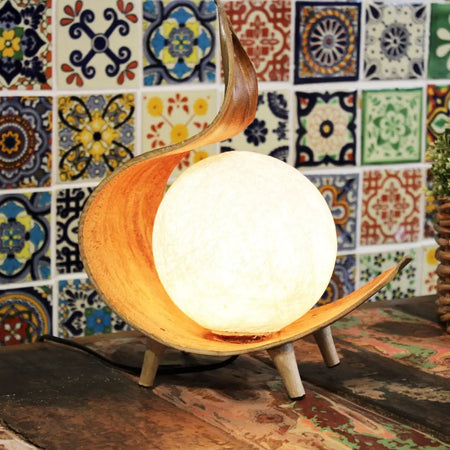 Natural coconut lamp chocolate twist with warm wooden crescent shape and glowing spherical bulb in warm tones