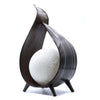 Dark wood sculptural coconut lamp with curved flame-like frame and textured white spherical globe natural coconut lamp