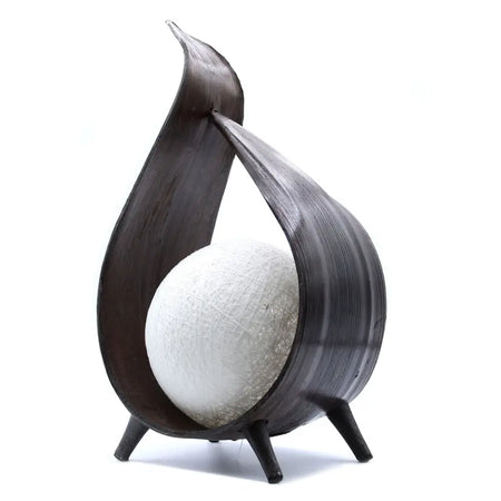 Dark wood sculptural coconut lamp with curved flame-like frame and textured white spherical globe natural coconut lamp