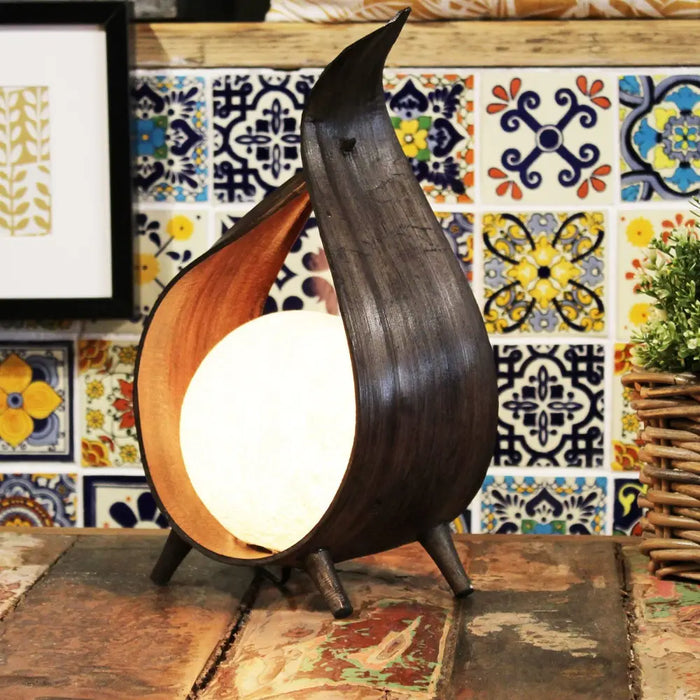 Natural coconut lamp with dark wood chocolate wrapover and curved teardrop shape glowing from inside
