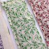 A cream cotton pouch with green floral pattern used as a natural cotton and wheat heating bag