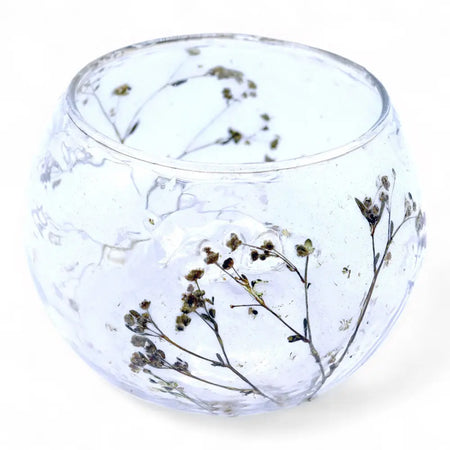 Clear glass candle holder with dried babys breath flowers made from recycled glass in a natural floral design