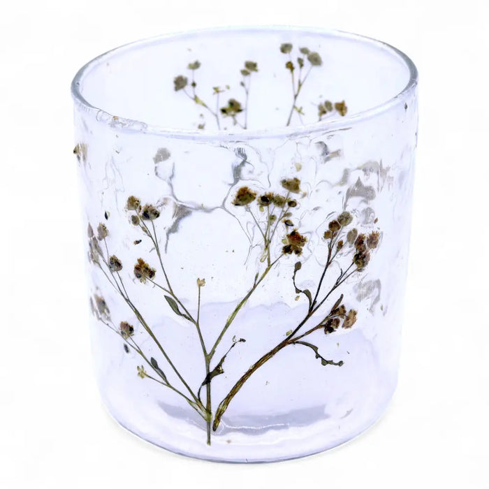 Clear glass candle holder with dried baby’s breath flowers embedded in recycled glass textured surface