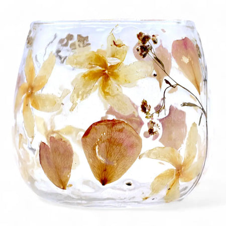 A clear glass candle holder with preserved yellow and pink flowers in recycled glass resin called natural floral glass straight candle holder rosa
