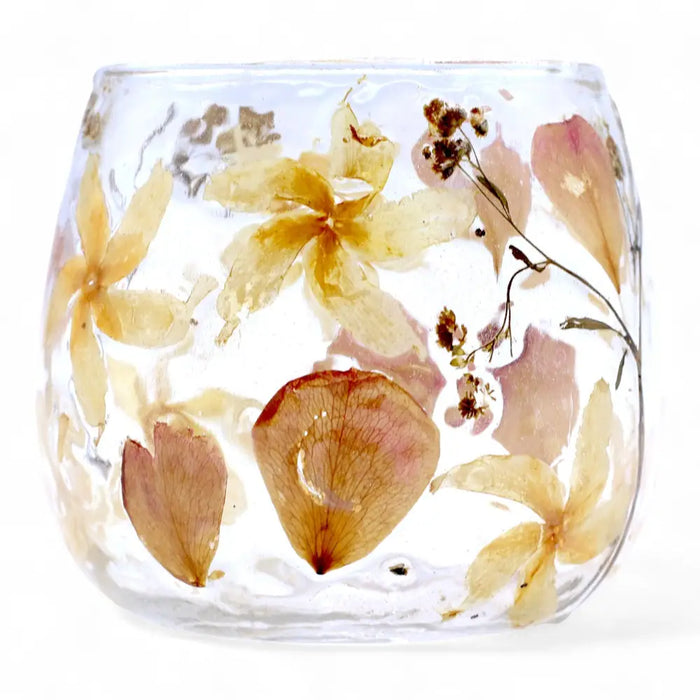 A clear glass candle holder with preserved yellow and pink flowers in recycled glass resin called natural floral glass straight candle holder rosa