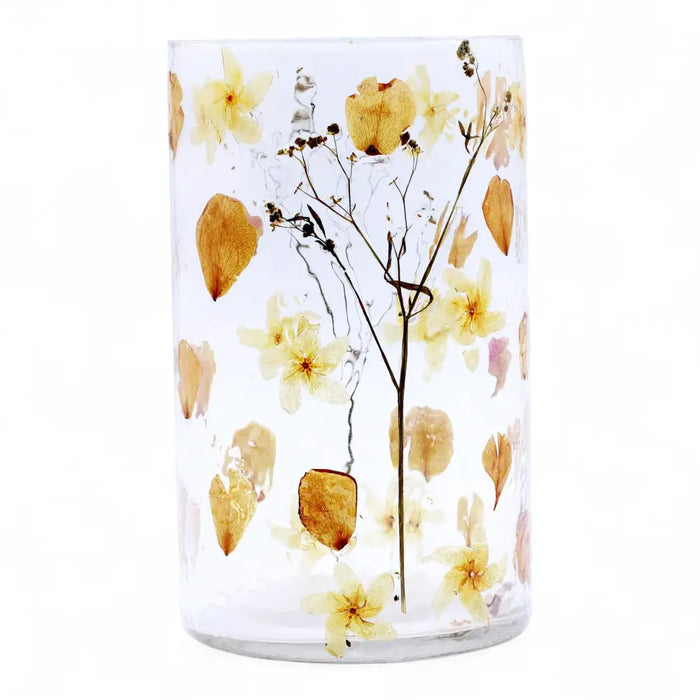 Clear cylindrical glass candle holder with preserved yellow and beige flowers in recycled glass resin vase