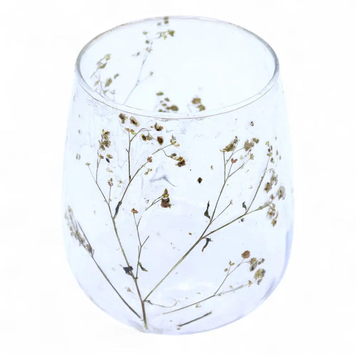 Clear glass recycled glass candle holder with delicate dried baby’s breath flowers embedded inside natural floral style