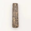 A large natural riverstone pestle in dark gray with lighter streaks and a rough natural texture