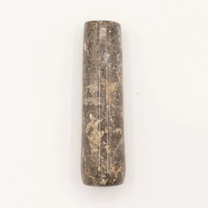 A large natural riverstone pestle in dark gray with lighter streaks and a rough natural texture