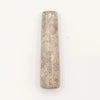 A textured translucent gray natural riverstone pestle with speckled surface and subtle vertical lines