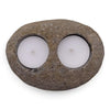 Natural riverstone tealight holder with rough texture oval shape and two white tealights in circular indentations