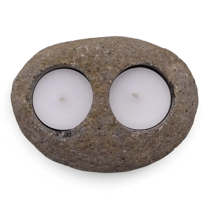 Natural riverstone tealight holder with rough texture oval shape and two white tealights in circular indentations