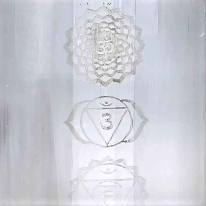 Silver chakra meditation plaque with engraved lotus and triangle symbols on natural selenite block lamp