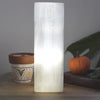 Natural selenite block lamp with translucent white pillar design and engraved chakra symbols for healing spaces