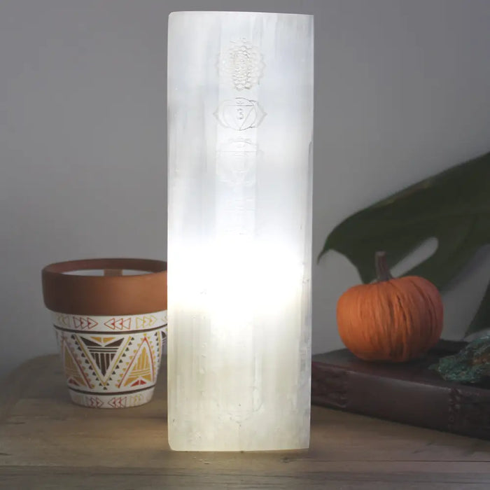 Natural selenite block lamp with translucent white pillar design and engraved chakra symbols for healing spaces
