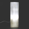 Natural selenite block lamp with etched chakra symbols glowing softly inside a translucent rectangular crystal block