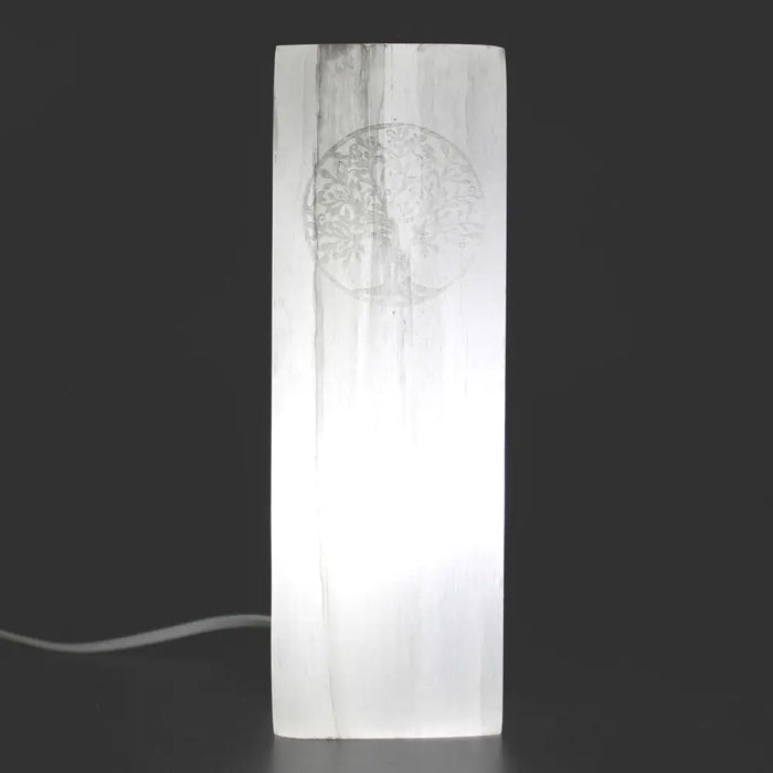Natural selenite block lamp with a translucent white slab and carved tree of life design for ambient lighting