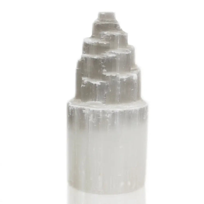 Natural selenite tower lamp in grayish white with a stepped pyramid top and smooth cylindrical base available in three sizes