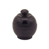 Black ceramic sugar bowl with rounded lid and ridges beside carved rosewood jar of patchouli solid perfume with pure beeswax