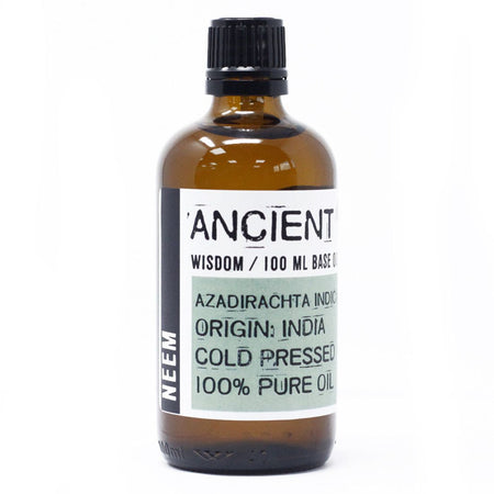 A brown glass bottle of ancient wisdom neem oil 100ml with black ribbed cap and white label showing product details