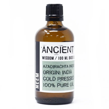 A brown glass bottle of ancient wisdom neem oil 100ml with black ribbed cap and white label showing product details