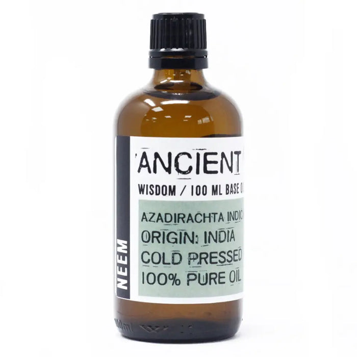 A brown glass bottle of ancient wisdom neem oil 100ml with black ribbed cap and white label showing product details