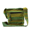 A handwoven green and yellow striped nepal sling bag with a wooden toggle zipper pull for summer beach use