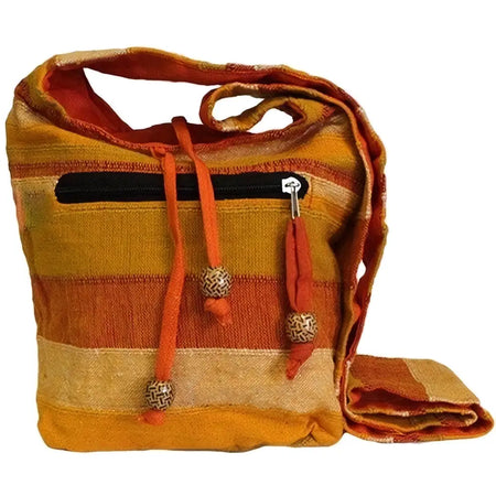 A vibrant orange and beige woven nepal sling bag with drawstring closure, decorative beads, and black zipper detail