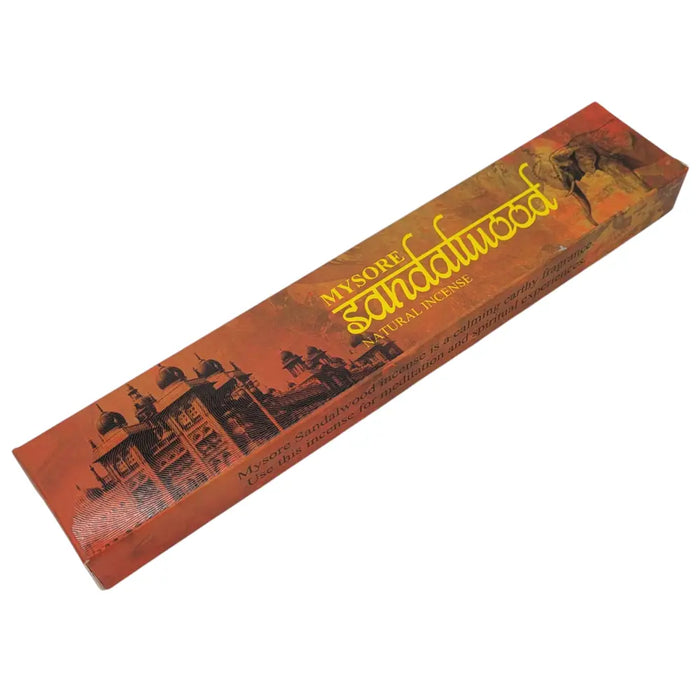 A rectangular orange cardboard box of myore sandalwood natural incense from new moon aromas with sepia architectural and elephant prints