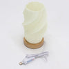 New wave lamp cloud twisted cream spiral textured with wooden base and usb charging cable on a white background